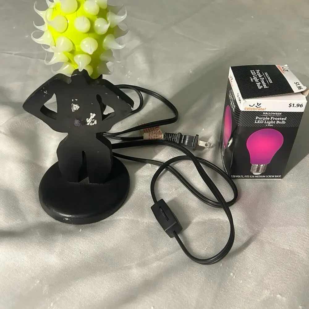 Lady shaped lamp with spikes yellow and purple light bulbs